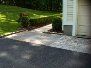 Driveway and walkway with garden hedge.