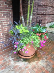 A large planter filled with flowers on the ground.