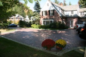 A view of a house with flowering plants outside