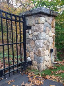 Stone gate pillar with autumn leaves.