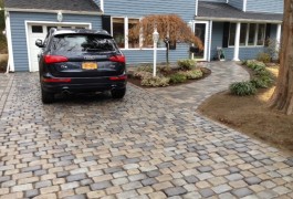 A car parked in the driveway of a home.