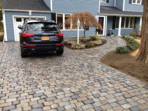 A car parked in the driveway of a home.
