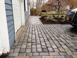 A brick walkway in front of a house.