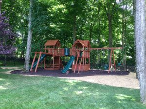 Wooden playground with slides and swings
