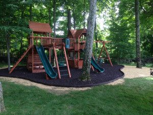 Playset surrounded by trees and grass