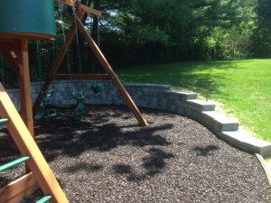 Playground with swings and wooden climbing structure.